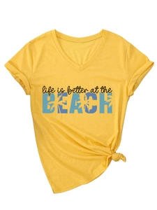 Detail of V-neck yellow cotton t-shirt with rolled sleeves and beach slogan print