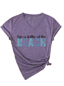 Detail of V-neck heather purple t-shirt with knotted hem and BEACH slogan print