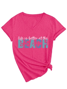 Detail of hot pink V-neck T-shirt with Life is better at the BEACH print and hem knot