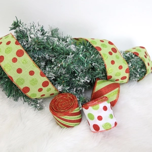 Macro view of glitter Christmas ribbon with red and green stripes and polka dots