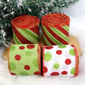 Detail of glittered striped and polka dot Christmas ribbons on a rustic wood tray