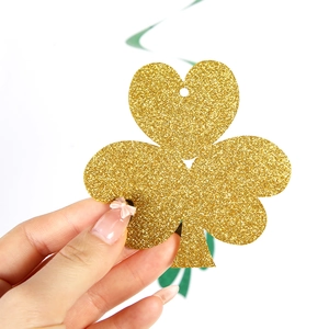 Glittery gold shamrock hanging decoration for St. Patrick's Day themed party events