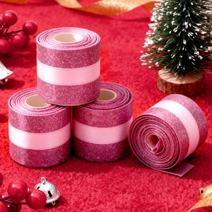 Detail of glittered dark pink ribbon with satin stripe on festive red velvet background