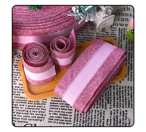 Detail of pink glitter ribbon rolls for Christmas gift box wrapping and DIY crafts