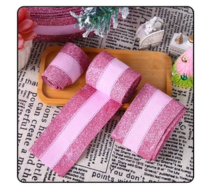 Detail of pink glitter Christmas ribbon with satin stripes and fine stitched edges