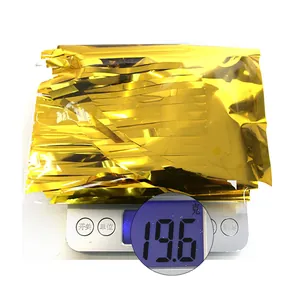 Detailed shot of gold foil fringe curtain showing a weight of 19.6g on a digital scale
