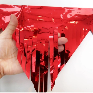 Detail of red metallic fringe tinsel garland for festive birthday party wall decorations