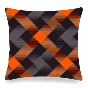 Detail of orange and dark grey buffalo plaid pattern on a square pillowcase
