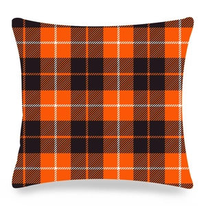 Detail view of orange and black plaid Christmas cushion cover with textured twill fabric