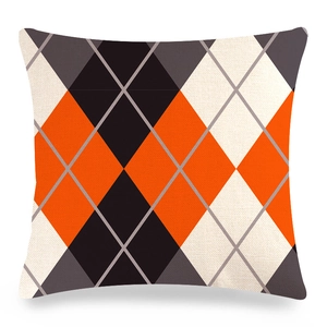 Detailed view of square Christmas pillowcase with orange and black argyle print texture