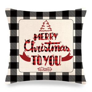 Détail de taie d'oreiller de Noël en lin avec carreaux noirs et lettrage festif rouge