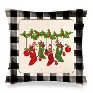 Close-up of linen pillowcase with buffalo plaid borders and festive Christmas decorations