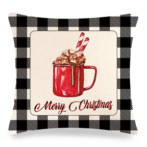 Close-up of linen pillow cover with buffalo plaid border and Merry Christmas print