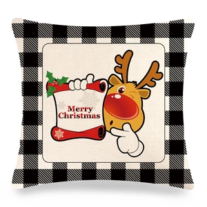 Close-up of linen pillowcase texture showing reindeer print and buffalo plaid borders
