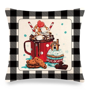 Detail of Christmas linen pillowcase with black plaid border and winter cocoa illustration