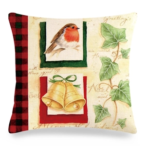 Close-up of linen pillow cover with robin bird, golden bell, and holiday greetings