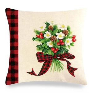 Close-up of linen pillow cover with robin red berries floral bouquet and plaid ribbon