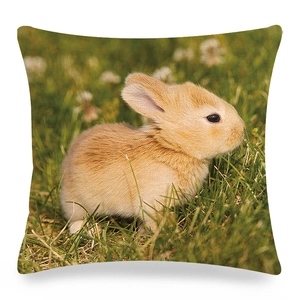 Detailed view of linen cushion cover with cute rabbit print and green grass pattern