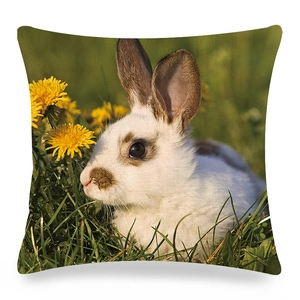 Detailed rabbit on green grass with yellow dandelions linen cushion cover print