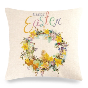 Detail of linen Easter pillow cover featuring a yellow chick and Happy Easter wreath
