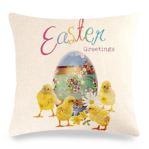 Detail of linen Easter pillowcase featuring yellow chicks and festive Easter Greetings text