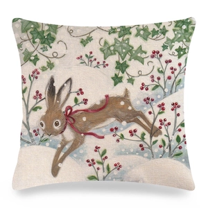 Close-up of linen pillowcase with rabbit illustration and red berries in winter forest