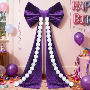 Detail of large purple velvet bow with white pearls for birthday party backdrop wall decor