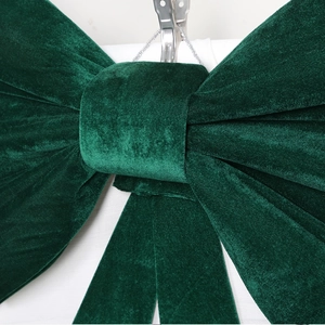 Detailed macro view of dark green velvet bow texture with fine handcrafted stitching
