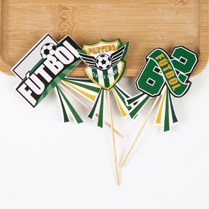 Macro shot of football themed cake toppers featuring Spanish text and club shield