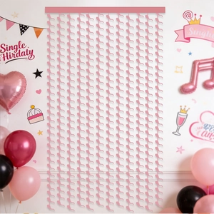 Pink streamer backdrop with wavy fringe details for birthday party wall decorations