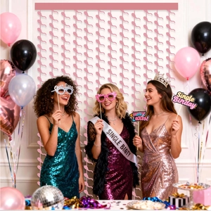 Pink tinsel fringe curtain and balloons set for a bachelorette birthday party scene