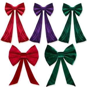 Large velvet bow decorations for weddings and parties in red, purple, and green colors