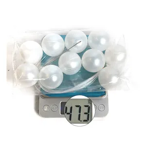 Macro shot showing exact weight of 47.3g for large white decorative pearl beads