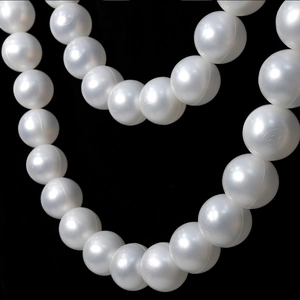 Close-up of large pearl white plastic bead strands with lustrous finish for weddings