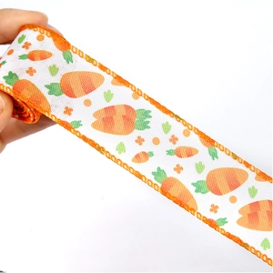 Detail von weißem Dekoband mit Karottenmuster und orangefarbener Nahtkante