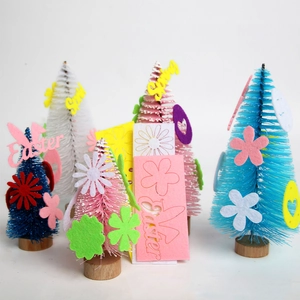 Detail of sisal Easter trees with colorful felt flowers and festive Spring wooden bases