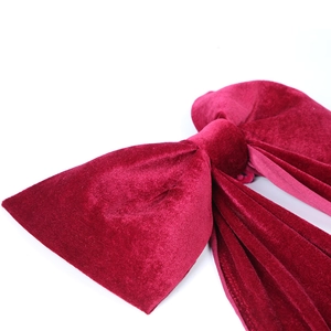 Large velvet bow decoration in deep wine red for wedding and event backdrops