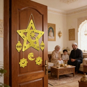 Close-up of golden star and moon hollow pendants hanging on a wooden door in home setting