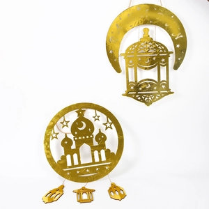 Macro detail of golden mirror Ramadan hanging decoration with crescent and lantern cutouts
