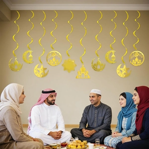 Golden Ramadan spiral hanging decorations with moon and mosque cutouts for party setting
