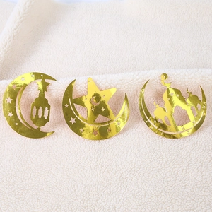 Detail of gold hollow Eid hanging decorations with moon and mosque silhouette designs