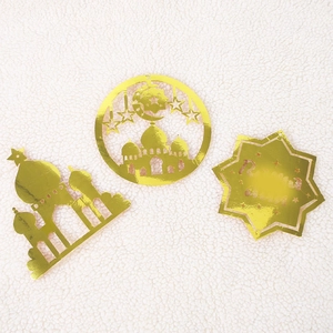 Detailed view of gold Ramadan decorations featuring mosque and crescent moon cutout designs