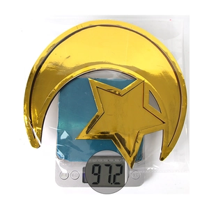 Golden moon and star decorative trays in packaging shown on scale for weight measurement