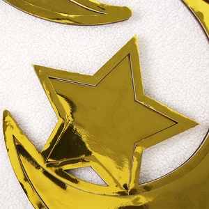 Close-up of golden moon and star trays with a polished mirror finish on white fleece