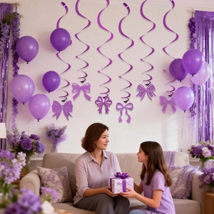 Purple Mother's Day ceiling swirls with glittery bow accents for party decoration