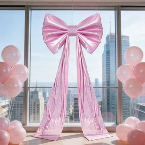 Large pink sequin bow decoration with long ribbons for wedding and party venue decor