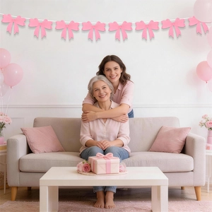Pink bow garland decoration hanging in a cozy living room for Mother's Day party setup