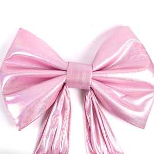 Large pink metallic wedding bow decoration for festive stage background and events