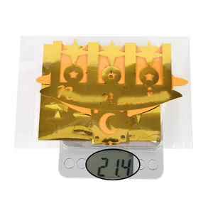Detailed view of gold mirror Ramadan star and moon wall stickers being weighed on scale