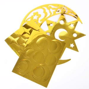 Detail of gold mirror-finish star and moon decals for festive party wall decoration